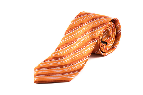 zusammengerollte orangefarbene Krawatte - Foto, Bild