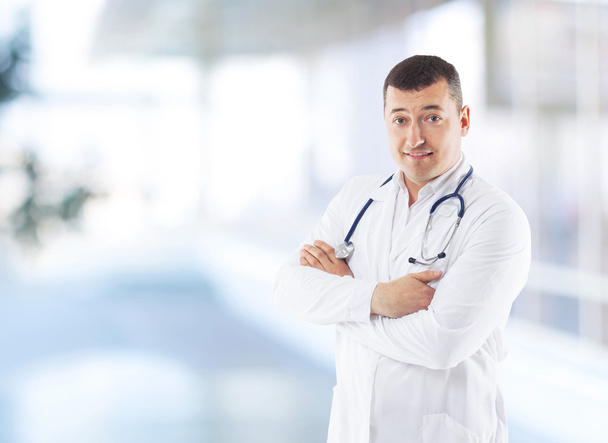 Closeup portrait of a happy senior doctor with stethoscope - 写真・画像