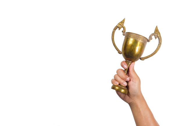 Holding the cup with white background.Conceptual of winning. - Photo, Image
