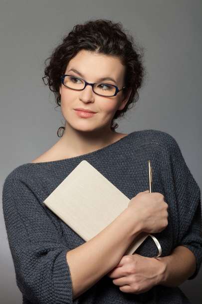 Beautiful young woman with her writing-pad - Photo, Image