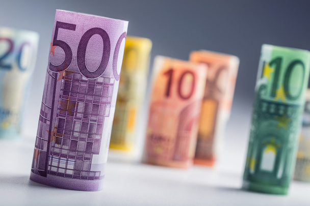 Several hundred euro banknotes stacked by value. Euro money concept. Rolls Euro  banknotes. Euro currency. Announced cancellation of five hundred euro banknotes. Banknotes stacked on each other in different positions. Toned photo - Photo, image