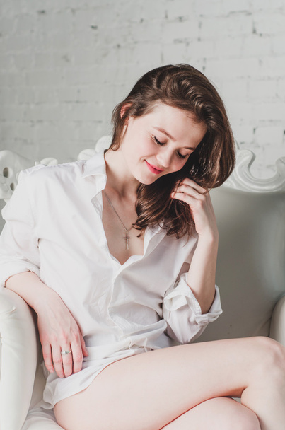 Romantic young woman portrait resting on sofa in boyfriend white shirt lifestyle - Fotografie, Obrázek