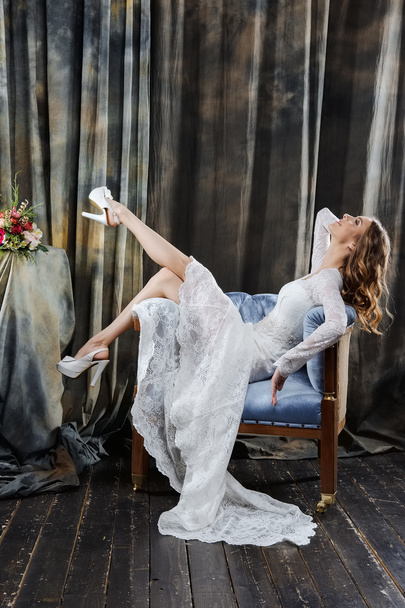 portret ładnej panny młodej w sukni ślubnej, siedząc w fotelu - Zdjęcie, obraz