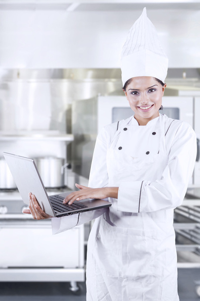 Female Chef Using Laptop - Фото, изображение
