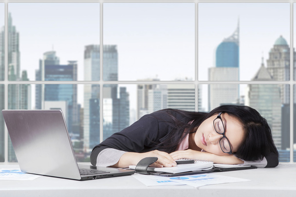 Young worker looks tired and sleeping in office - Fotoğraf, Görsel