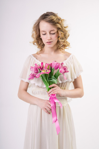 Beautiful blonde spring girl with flowers - Valokuva, kuva