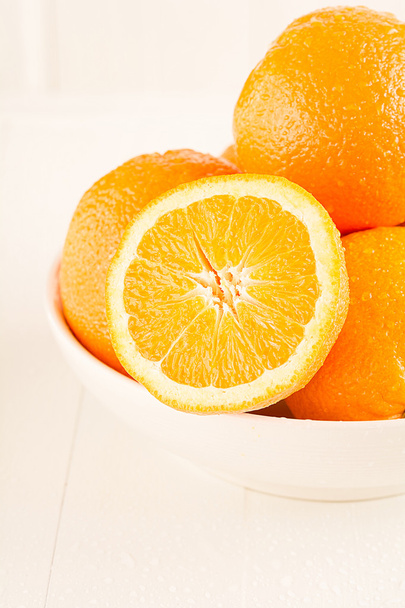 Les oranges se trouvent dans un bol en porcelaine
 - Photo, image