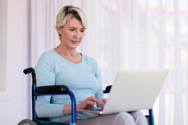 disabled woman with laptop computer - Photo, image
