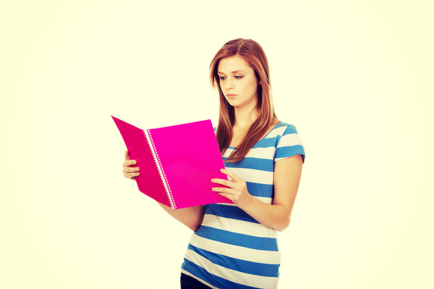 Young smiling teenage woman holding books - Photo, image