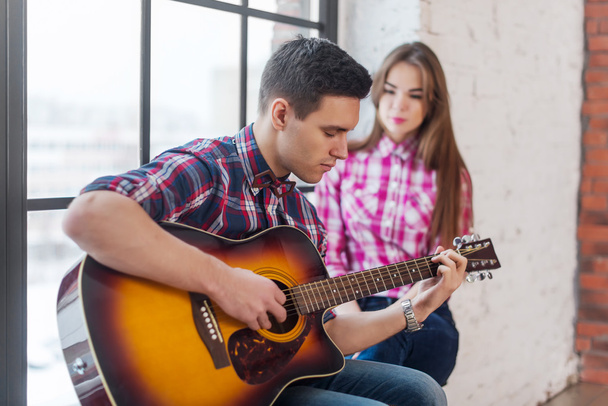 Genç adam şarkı gitar çalmak için kız arkadaşı - Fotoğraf, Görsel