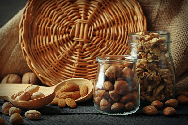 Mix of nuts in jars and spoons - Foto, Bild