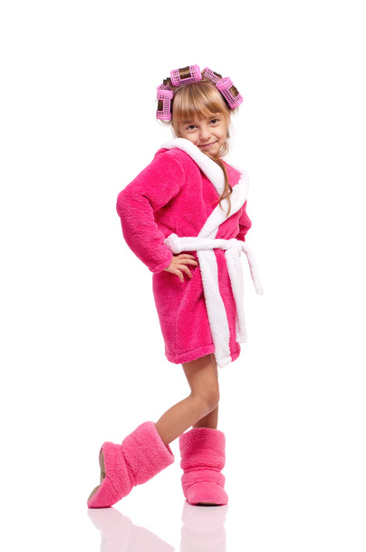 Little girl in pink bathrobe with curlers - Фото, изображение