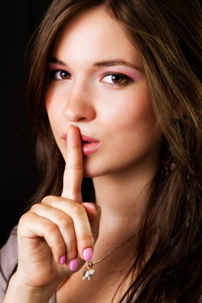 Gossip - woman with finger over lips - Zdjęcie, obraz