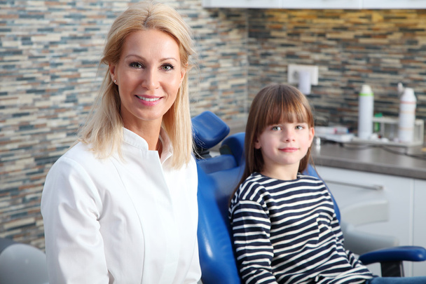 female dentist and her child patient. - Fotó, kép