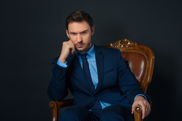 Confident businessman sitting in armchair - Photo, Image