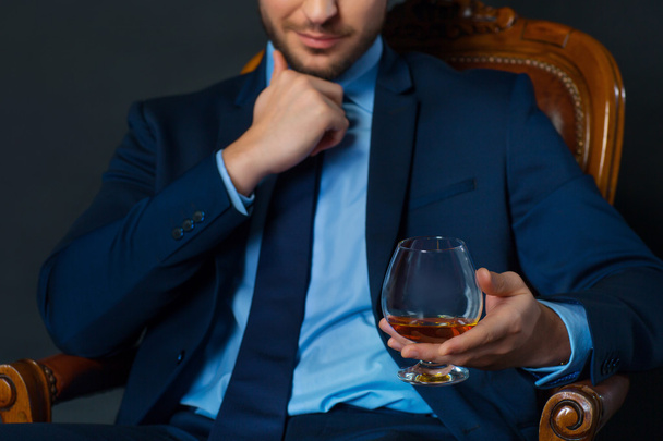 Handsome businessman drinking alcohol - Fotó, kép