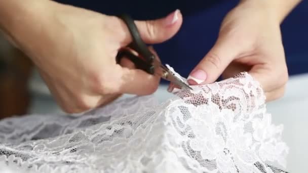 Hand cut white fabric with scissors of dressmaker cutting a cloth - Кадри, відео