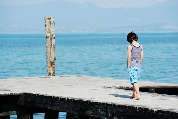 Little boy walking on dock - Photo, image