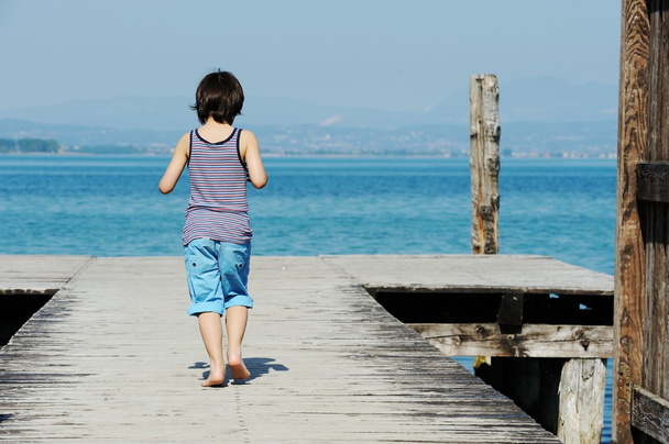 Little boy walking on dock - Zdjęcie, obraz