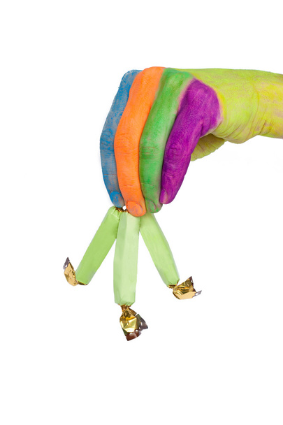 renkli elini tutarak veya üç yeşil şekerler veriyor - Fotoğraf, Görsel