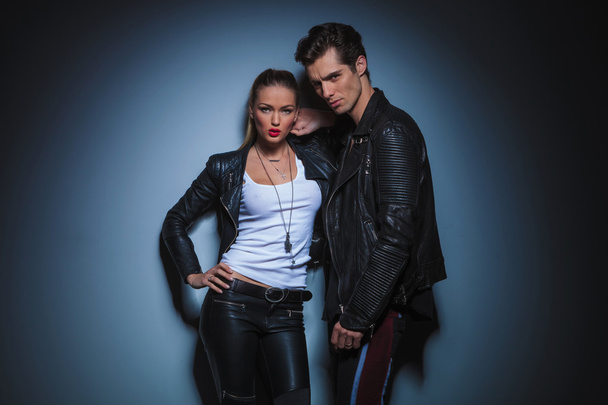 woman in leather resting her hand on boyfriend's shoulder  - Фото, изображение
