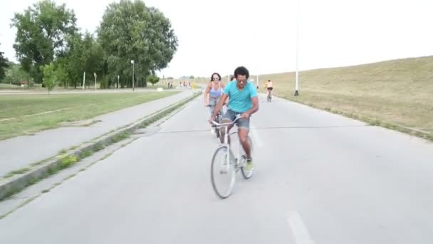 young  adults cycling outdoors - Video, Çekim