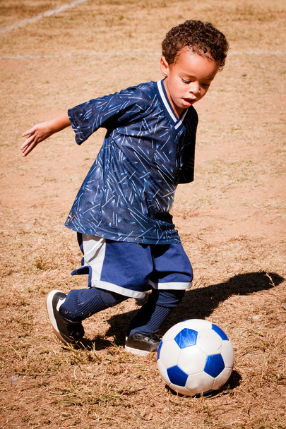 Young African American boy playing soccer - Φωτογραφία, εικόνα