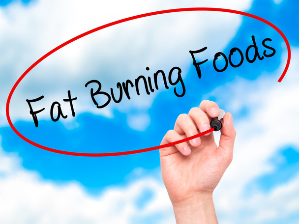 Człowiek w zapasie pismo Fat Burning Foods z czarnego markera na wizualne s - Zdjęcie, obraz