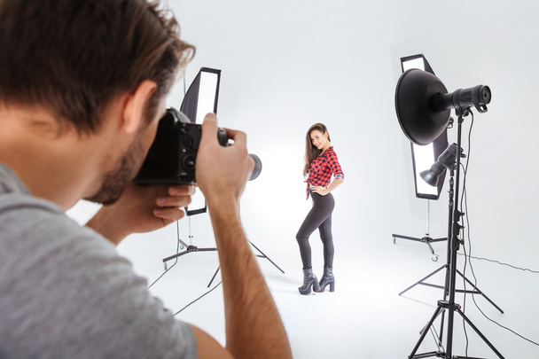 Photographer working with model in studio  - Fotó, kép