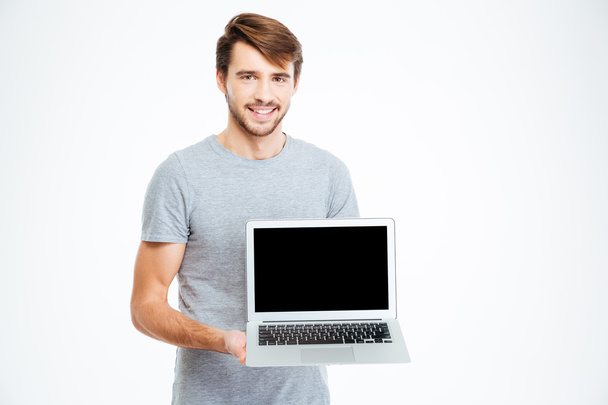 Man showing blank laptop computer screen - Fotó, kép