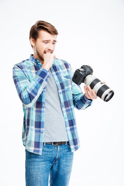 Stressed male photographer holding photo camera - Valokuva, kuva