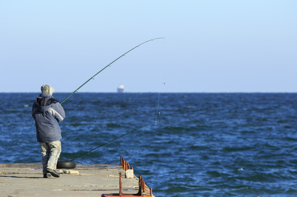 Fisher at the pier - Photo, Image