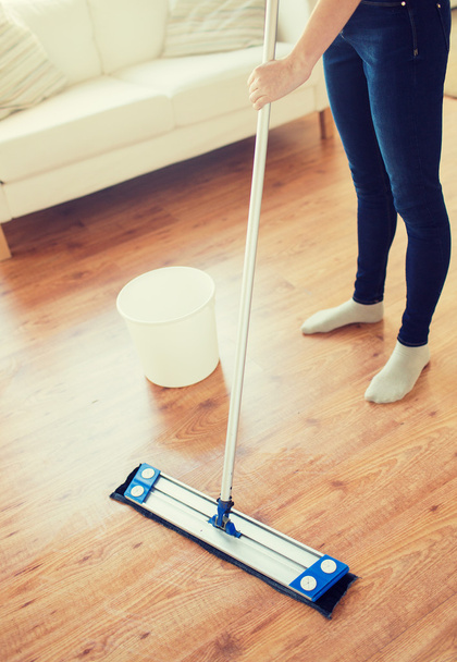 close up of woman with mop cleaning floor at home - Fotografie, Obrázek
