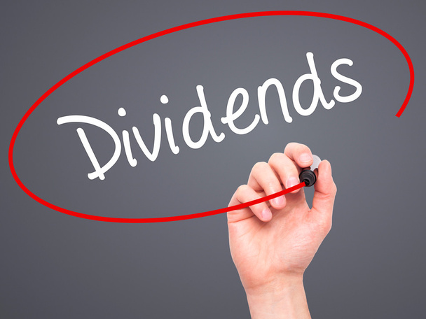 Man Hand writing Dividends with black marker on visual screen - Photo, Image