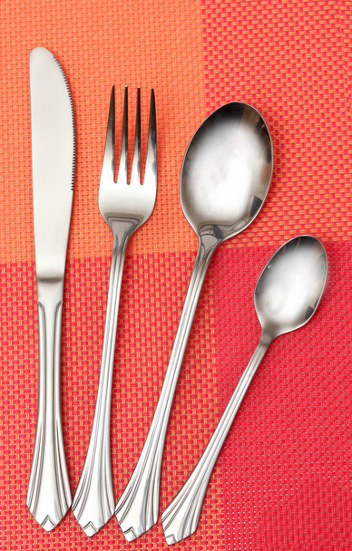 Fork, spoon and knife in a red cloth - Fotó, kép
