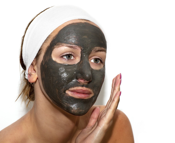 Deep sea mud mask treatment on the woman face - Foto, afbeelding