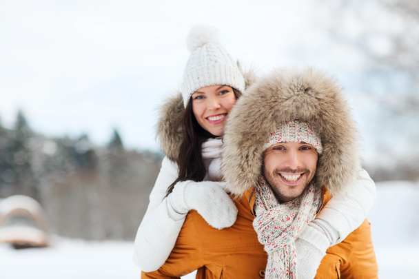 happy couple having fun over winter background - Фото, зображення