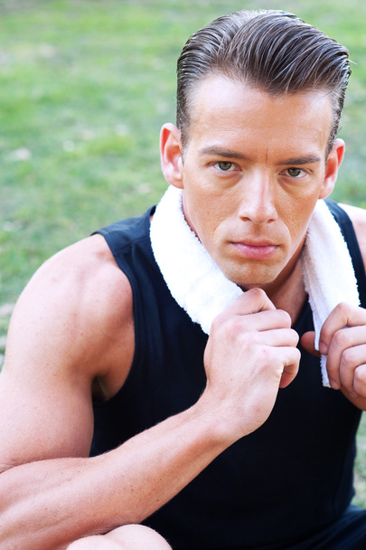 Portrait of a young athletic man with workout towel - Photo, Image