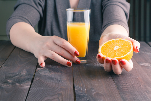 woman hand holding glass of orange juice - Fotó, kép