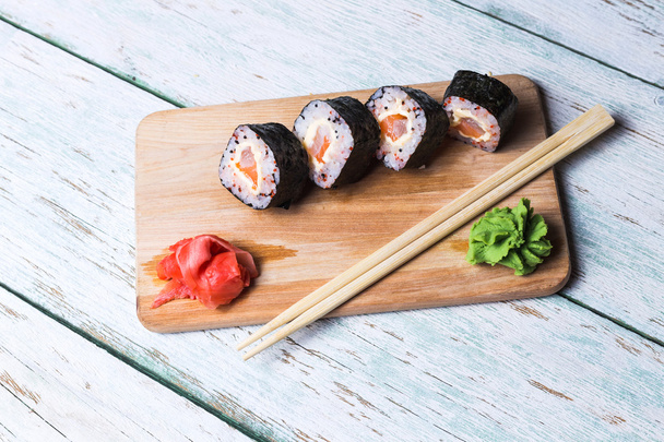 Sushi roll on white wooden background - Φωτογραφία, εικόνα