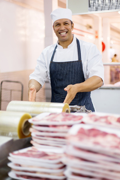 butcher wrapping meat - Photo, image