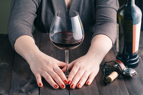 Female hand holding big glass of red wine - Фото, изображение