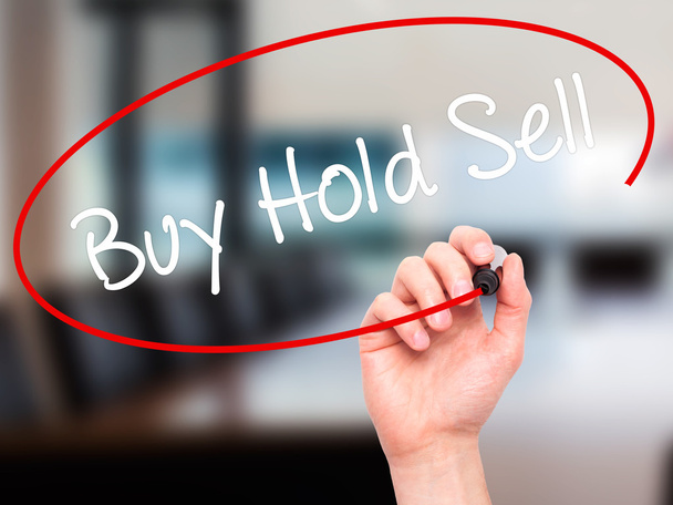 Man Hand writing  Buy Hold Sell with black marker on visual scre - Fotoğraf, Görsel