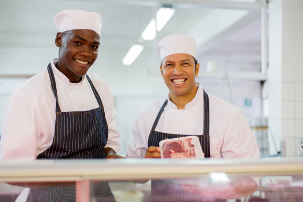 butchers standing at butchery counter - Photo, image