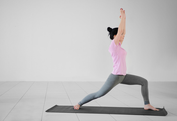 Woman does yoga exercises in the gym - Φωτογραφία, εικόνα
