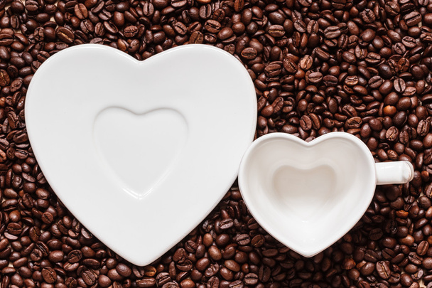 cup and saucer on coffee beans background - Photo, Image