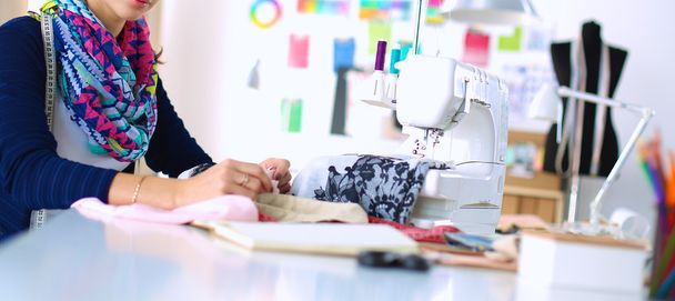 Dressmaker designing clothes pattern on paper - Fotó, kép