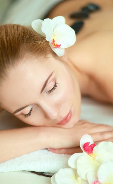 Beautiful young woman getting spa massage, lying on salon - Foto, Imagem