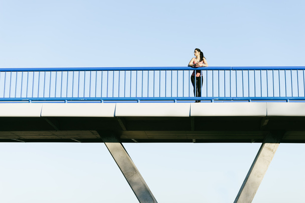 Young fitness woman runner running on city bridge. - Foto, Imagem