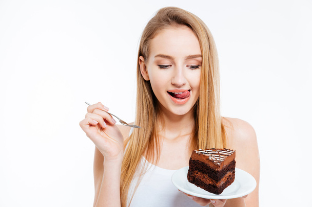 Attractive playful woman eating piece of chocolate cake - Zdjęcie, obraz